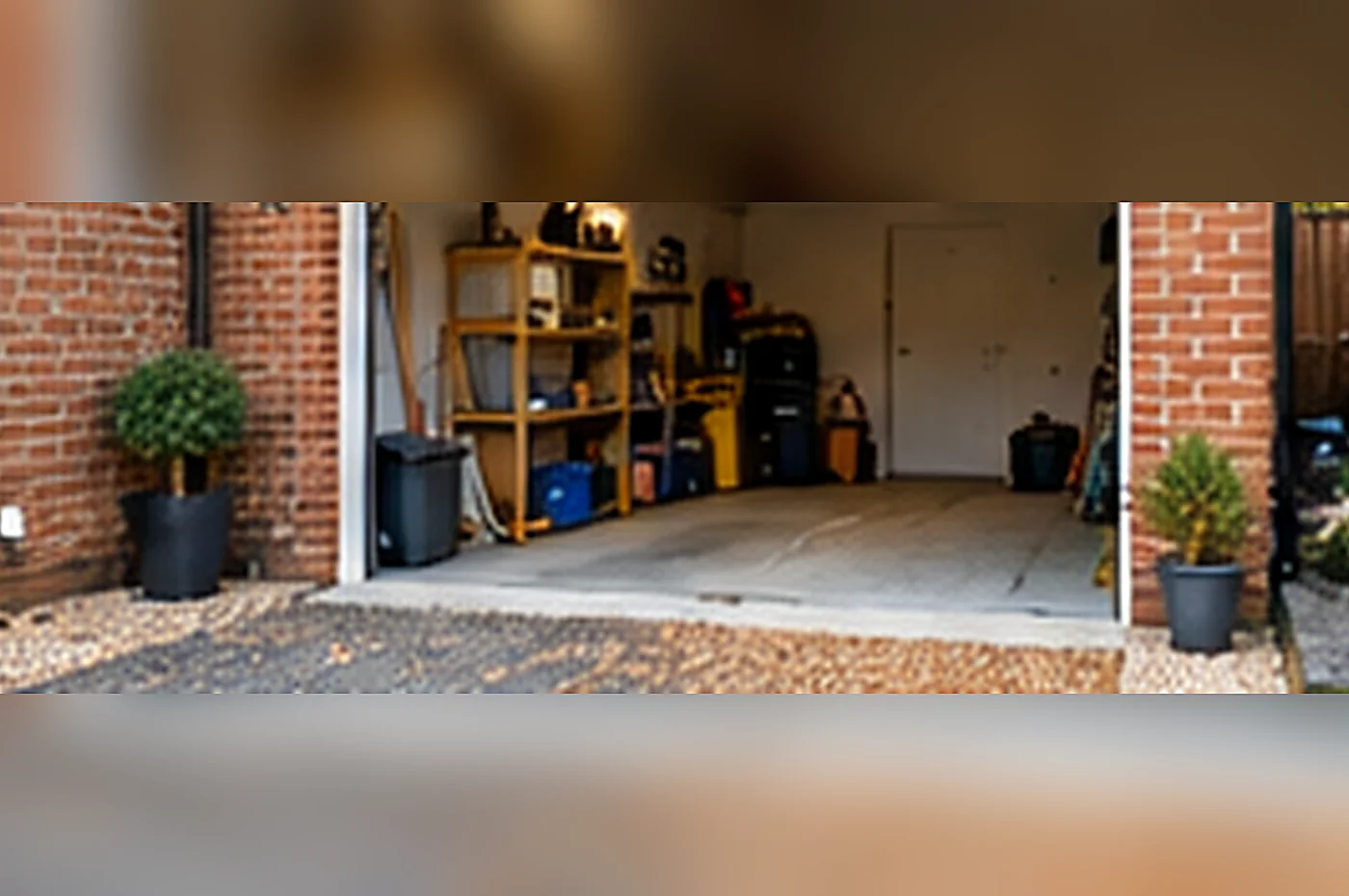 garage conversion party wall - brick garage prepared for conversion with its door opening and internal storage