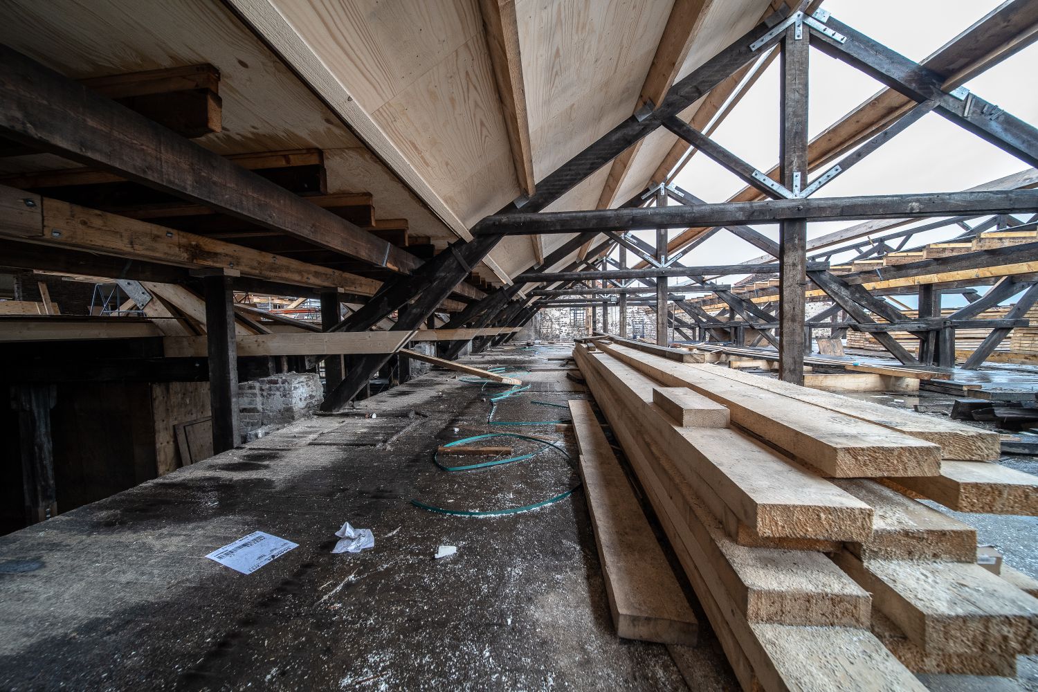 loft conversion steel beams - exposed roof timbers and trusses inside an unfinished loft structure